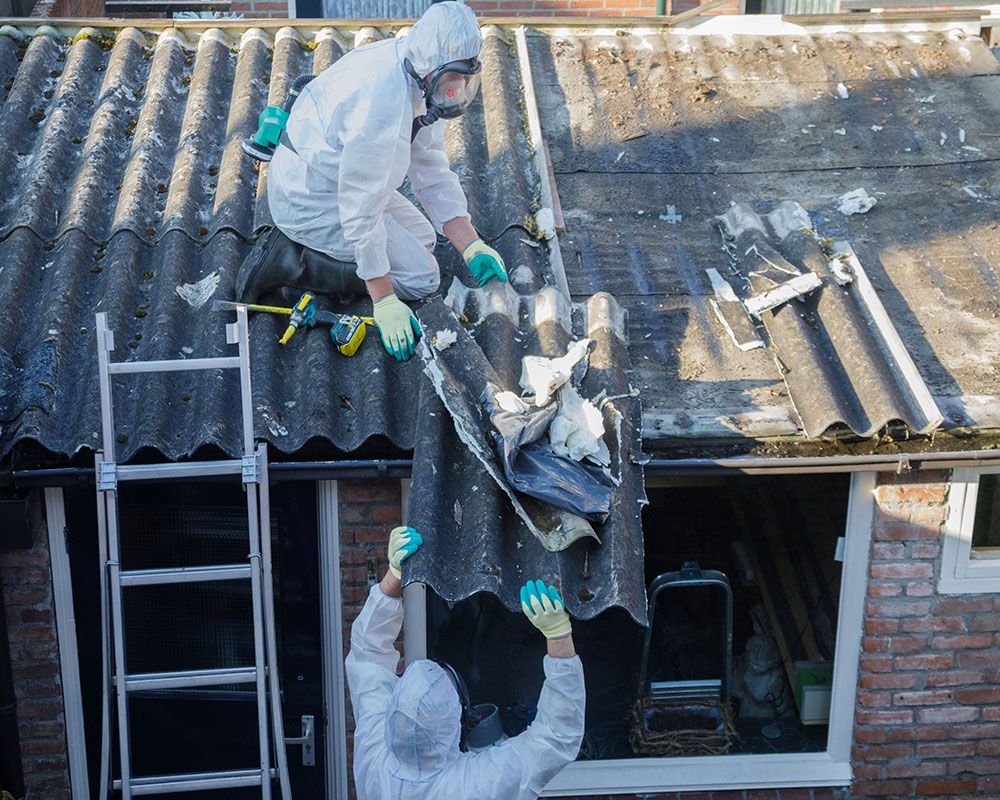 Clearaway team members in protective gear during asbestos removal